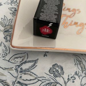 This is a matte bright true red. The formulation is creamy and super pigmented